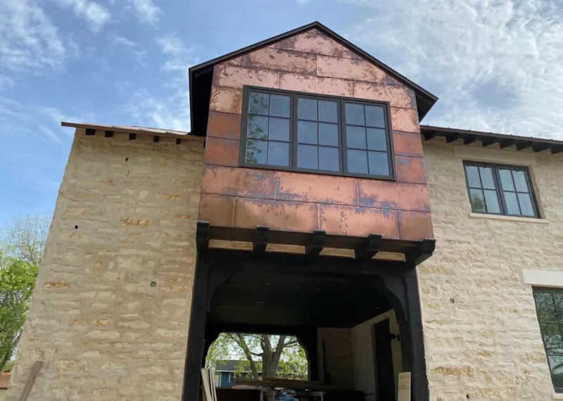 Copper metal panel facade on a stone building for Skylight Installation in Maili